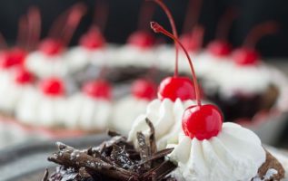 Black Forest Pie: Chocolate pie crust filled with ganache and homemade kirsch cherry pie filling, topped with chocolate curls, whipped cream, and maraschino cherries. | siftandwhisk.com