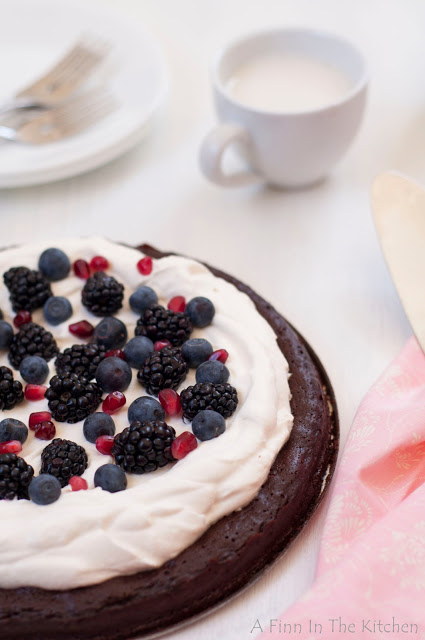flourless chocolate honey cake with berries and a cloud of whipping cream 0891