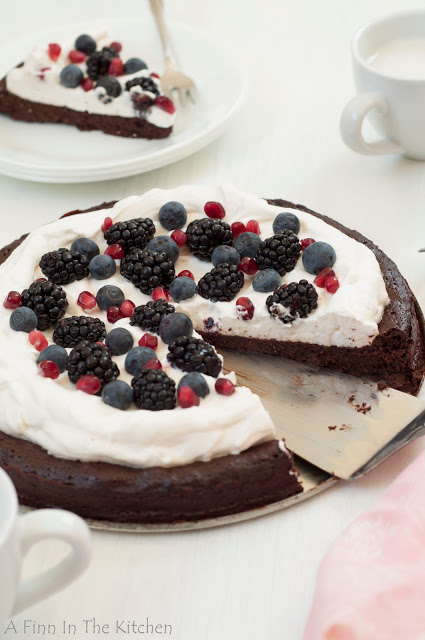 flourless chocolate honey cake with berries and a cloud of whipping cream 0938