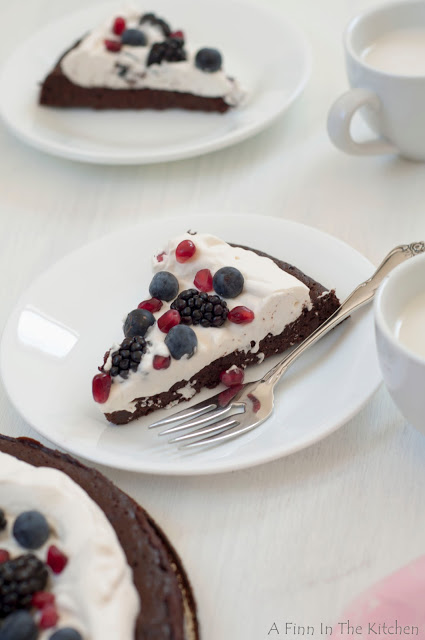 flourless chocolate honey cake with berries and a cloud of whipping cream 0973