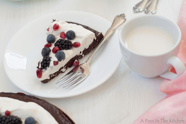 flourless chocolate honey cake with berries and a cloud of whipping cream 0977