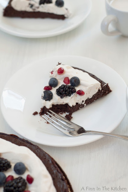 flourless chocolate honey cake with berries and a cloud of whipping cream 0979